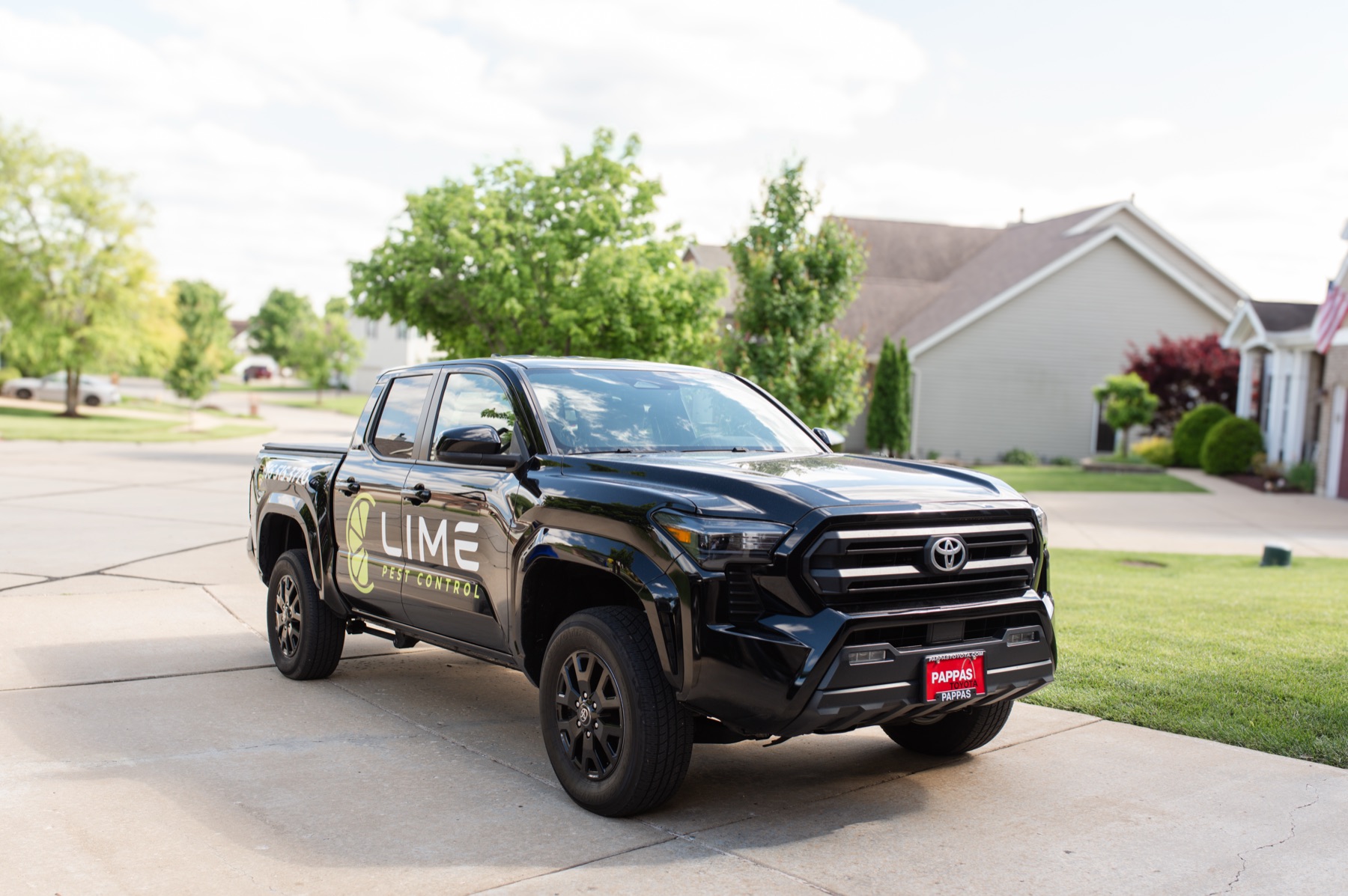 Lime Pest Control service vehicle in a residential neighborhood