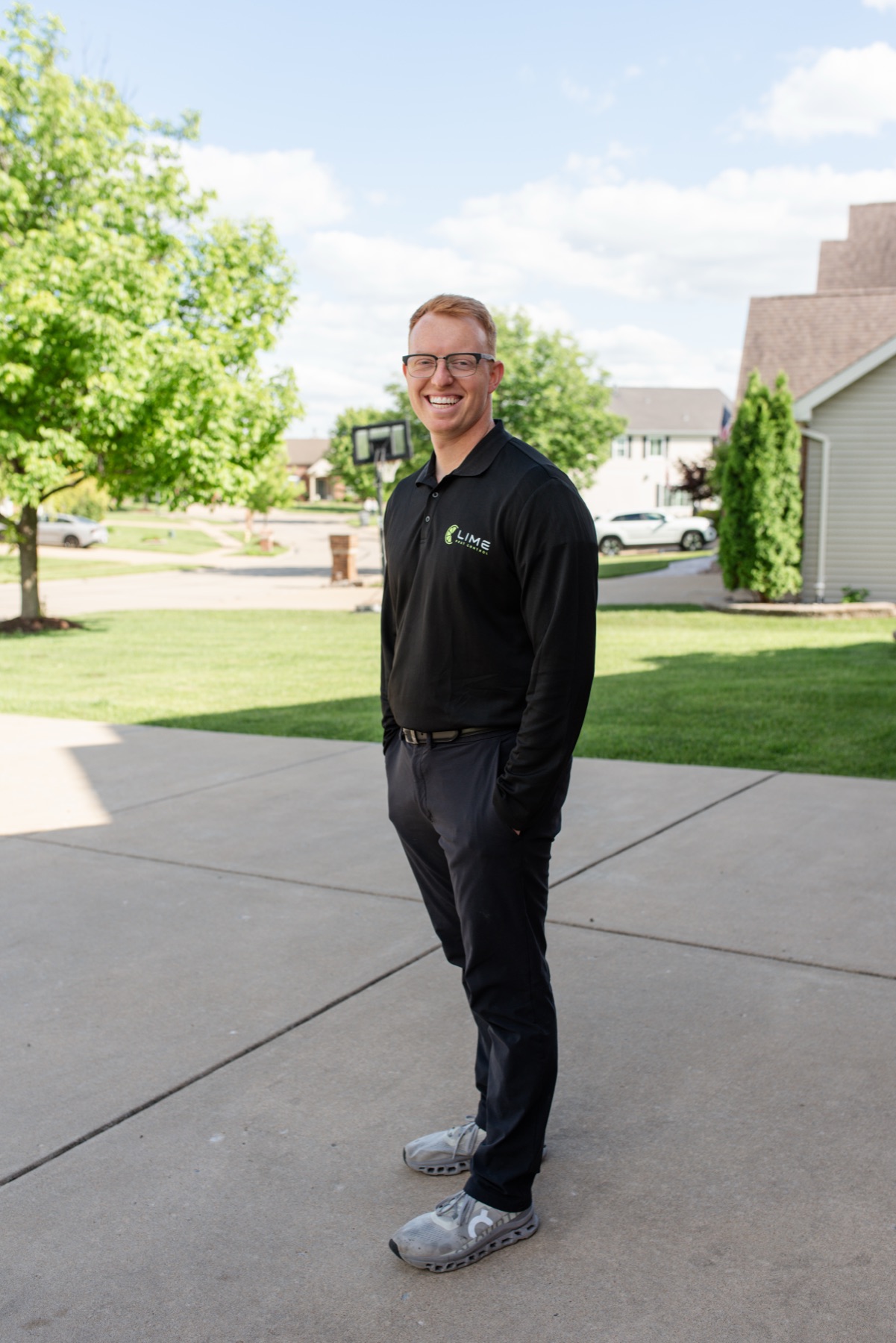 Lime Pest Control technician standing in a residential neighborhood
